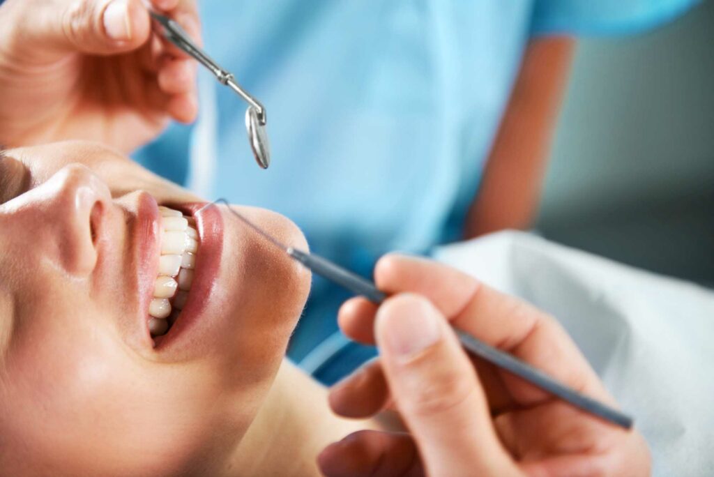 patient smiling as the doctor goes to exam teeth