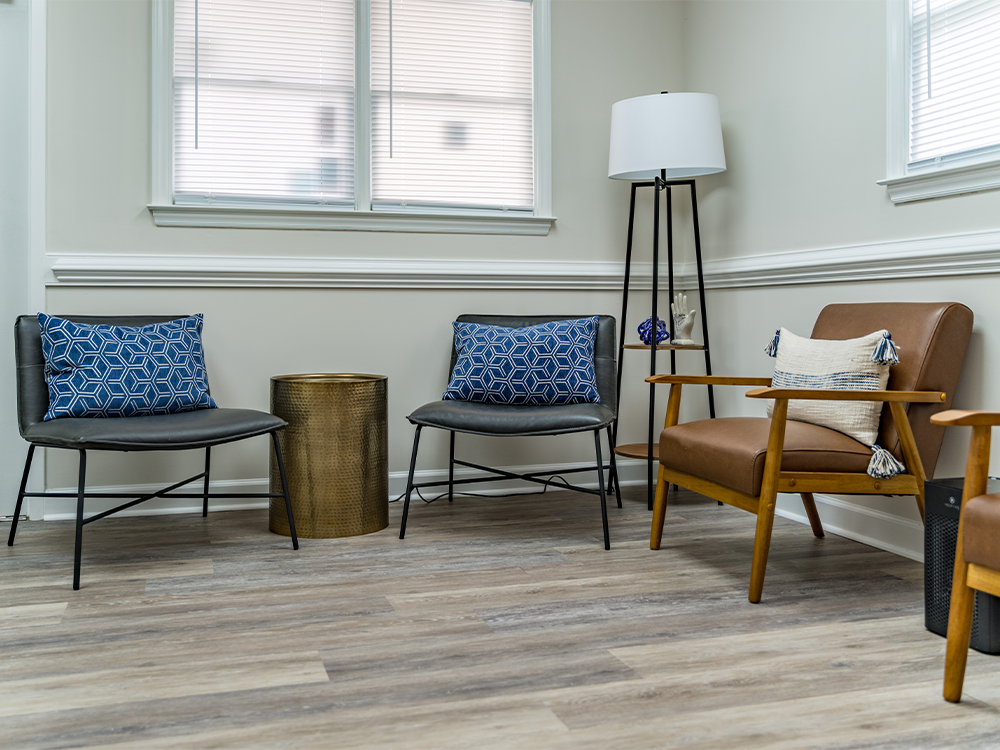 Elan Dental waiting area showing chairs and a lamp