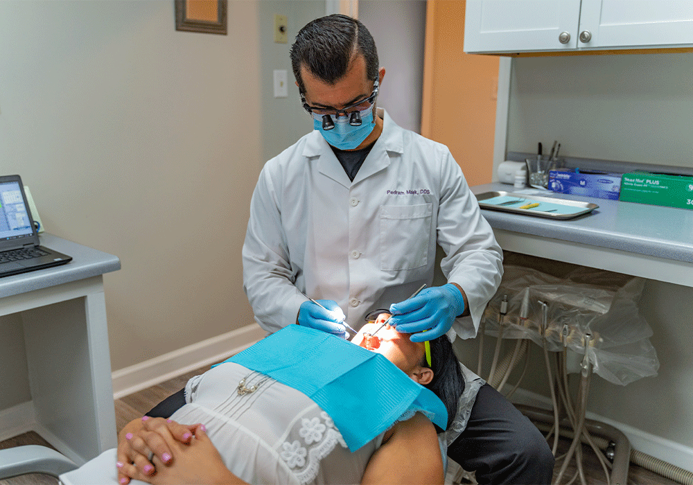 Dr. Malek examining a patient's mouth