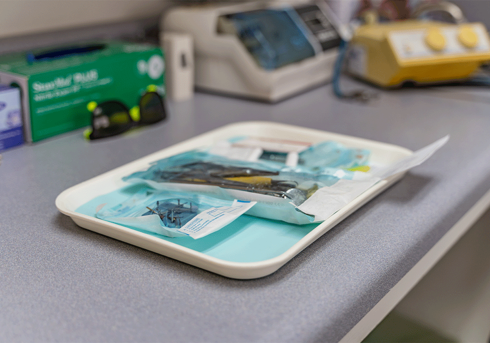 dental tools, still in sterile packages, sitting on an exam tray